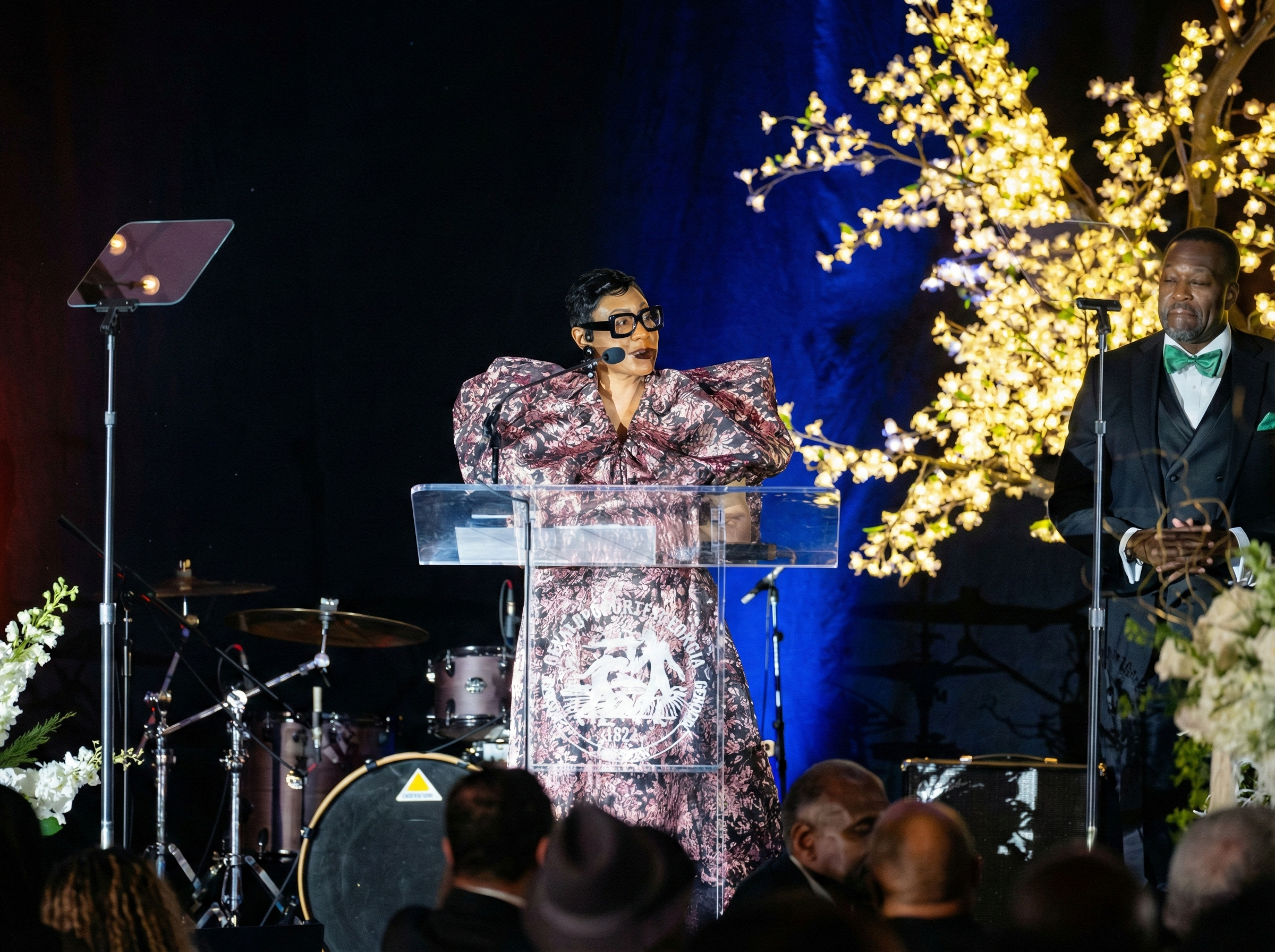 Lorraine Cochran-Johnson giving a speech at a formal evening gala.