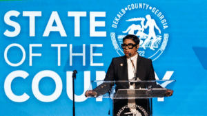 Lorraine Cochran-Johnson speaking at a "State of the County" event podium.